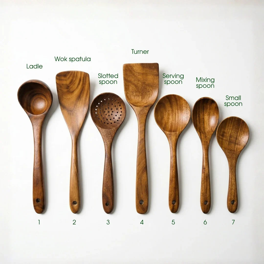 Acacia wood utensils in a wooden holder on a sunlit kitchen counter